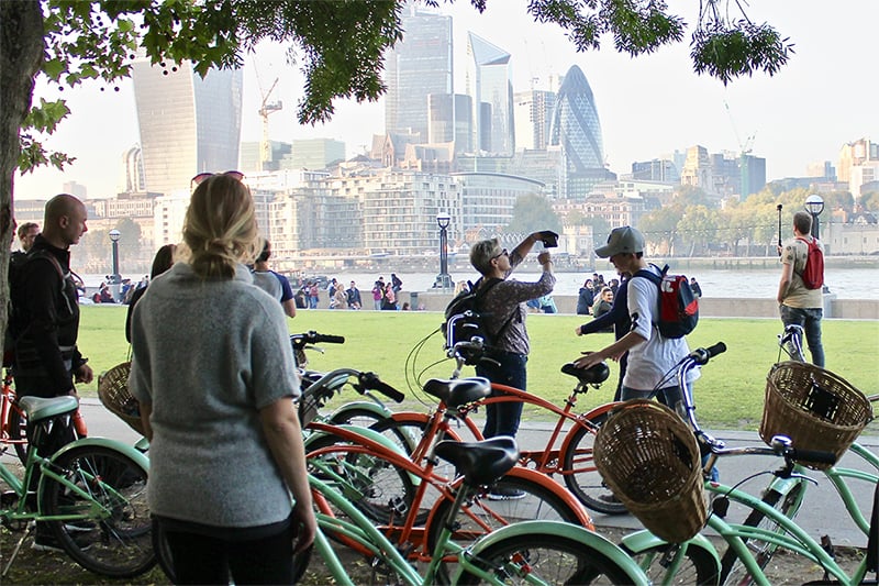 a group of cyclists relaxing and taking photos on a grand london bike tour